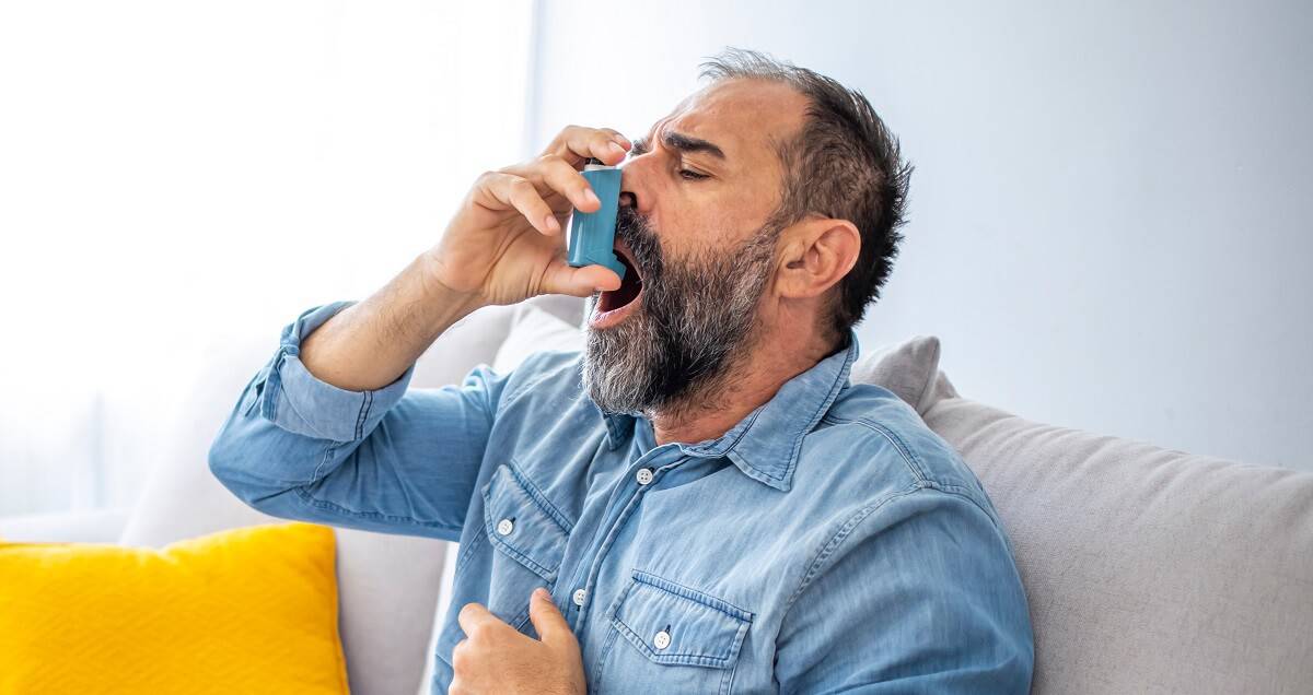 man with an asthma inhaler in his hands